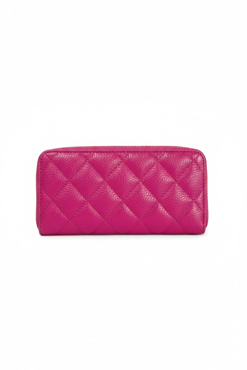 A light blue LE BORSETTE LEATHER QUILTED WALLET with diamond stitching on a white background features a zip-around closure, gold zipper pull, and multiple card slots.
