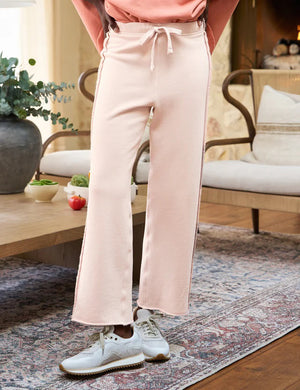 The FRANK & EILEEN BELLA ITALIAN SWEATPANT is a light beige, wide-leg knit pant with a drawstring waist and subtle side trim, shown flat on a white background.