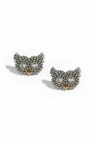 The MIGUEL ASES - OWL STUD EARRINGS WITH SWAROVSKI CRYSTAL by MIGUEL ASES, INC. are handcrafted in America and feature owl shapes with sparkling flower-like Swarovski crystal eyes, arranged on a white background.