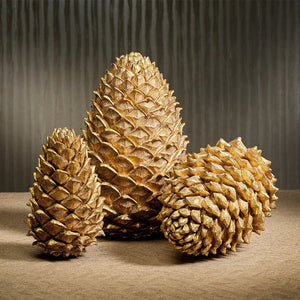 The LARGE GOLDEN PINECONE by ZODAX stands upright against a plain white background, making it a perfect addition to your holiday décor.