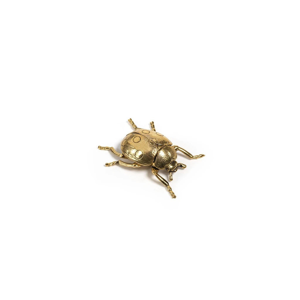 The ZODAX DECORATIVE GOLD LADYBUG is a small gold-colored figurine with detailed legs and body, measuring 2.75 x 2.5 x 1 inches, shown on a plain white background.