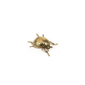 The ZODAX DECORATIVE GOLD LADYBUG is a small gold-colored figurine with detailed legs and body, measuring 2.75 x 2.5 x 1 inches, shown on a plain white background.