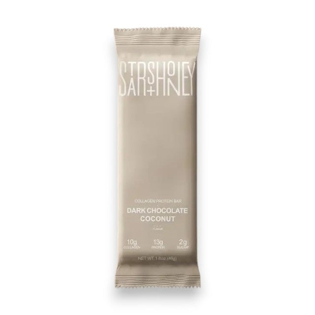 A STARS+HONEY - DARK CHOCOLATE COCONUT collagen protein bar is displayed on a coordinating beige background. The packaging emphasizes this low sugar protein bar from STARS+HONEY, highlighting that each bar contains 10g collagen, 13g protein, and only 2g sugar.