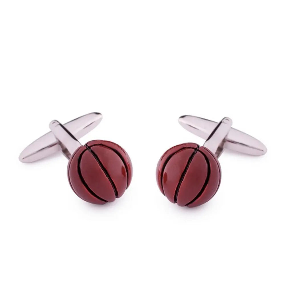 STOLEN RICHES - BASKETBALL CUFFLINKS by STOLEN RICHES: hand-painted silver cufflinks with round red, black-detailed basketball ends, shown on a white background—an ideal men's accessory.