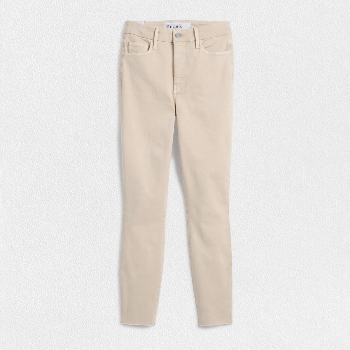 The FRANK &amp; EILEEN SLIGO SKINNY JEAN is a pair of beige, high-waisted skinny jeans crafted from sustainable Italian Performance Denim. They feature a high-rise contour waistband, five pockets, button and zip closure, and a &quot;Frank&quot; label on the waistband. The jeans are displayed against a white textured background.