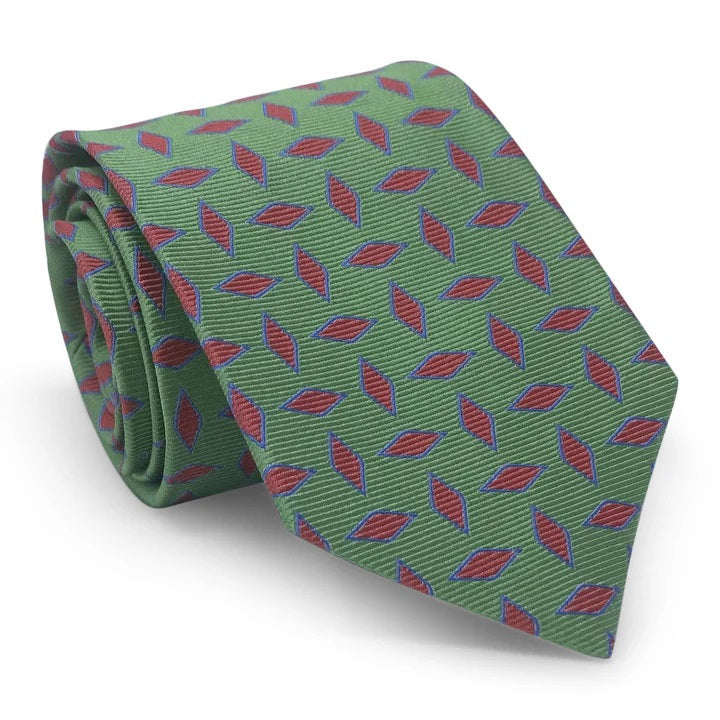 The BIRD DOG BAY PETER-BLAIR Archer Woven Silk Tie in Green, handmade in New York, features a bold geometric red diamond pattern outlined in blue and showcases its pointed end when displayed flat.