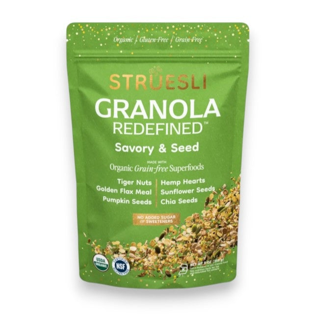 A green bag of STRUESLI - SAVORY SEED GRANOLA stands upright, showcasing seed granola ingredients like tiger nuts, pumpkin seeds, sunflower seeds, and highlighting nut-free, no sweeteners, and small batch production.