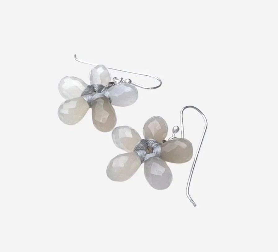 The ANN LIGHTFOOT Faceted Grey Onyx Glower Earrings feature blossom-inspired designs with five translucent, teardrop-shaped grey onyx petals and sterling silver hooks. The image background is plain white.