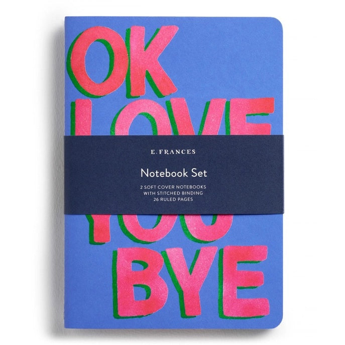 This E. FRANCES PAPER set includes two stitched OKLOVEYOUBYE notebooks, each 8.5 x 6 inches with soft covers, 26 ruled pages, and bold pink and green “OK LOVE YOU BYE” text on blue.