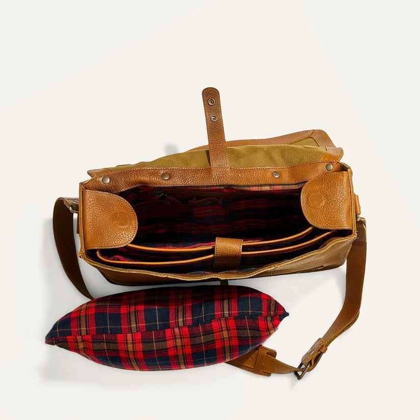 The WILL LEATHER GOODS - KENT MESSENGER BAG IN TAN features full-grain leather, a top handle, front flap with metal clasp, adjustable shoulder strap, and a laptop sleeve, shown against an off-white background.