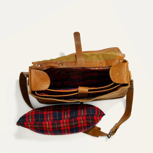 The WILL LEATHER GOODS - KENT MESSENGER BAG IN TAN features full-grain leather, a top handle, front flap with metal clasp, adjustable shoulder strap, and a laptop sleeve, shown against an off-white background.