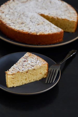 A light blue CUP4CUP bag labeled "Gluten Free" contains CUP4CUP ANCIENT GRAINS FLOUR. The packaging displays a measuring cup and notes it's a dairy-free all-purpose flour with 24g whole grains per serving.