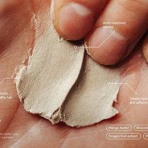 A round black container labeled "JACK HENRY - HAIR PUTTY" features white text promoting hydrating, volumizing benefits with medium hold and a matte finish. The Jack Henry container casts a shadow on a white background.