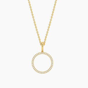 The ELLA STEIN - STANDING O PENDANT NECKLACE by ELLA STEIN features a delicate gold link chain showcasing a circular gold-plated pendant, elegantly outlined with small white gemstones. Photographed on a plain white background, this simple yet sophisticated necklace brings together the enduring appeal of stainless steel jewelry and modern design.