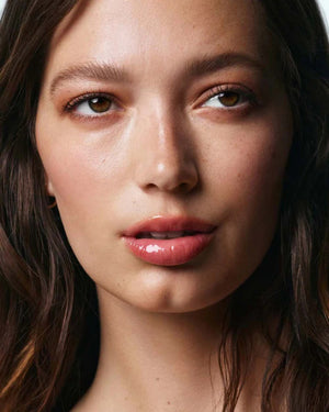 A 15ml tube of U BEAUTY THE PLASMA LIP COMPOUND, featuring white text and logo on the front, is shown upright on a white background.