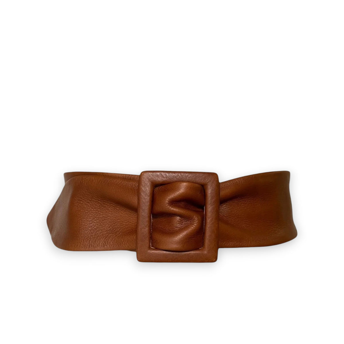 A person in a long-sleeved black dress with a button-up front stands against a white background. The outfit's relaxed, stylish look is enhanced by one hand in the pocket and the versatile APROPOS BELT by ADA.