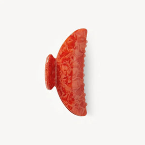 The MACHETE - MIDI HAIRLOOM CLAW IN POPPY by MACHETE is a large orange marbled Italian acetate hair claw with wide teeth, shown against a plain white background.