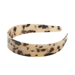 The MACHETE WIDE HEADBAND by MACHETE is crafted in Italy from glossy, tortoiseshell-patterned acetate and features a wide design with a distinctive yellow and black mottled finish.