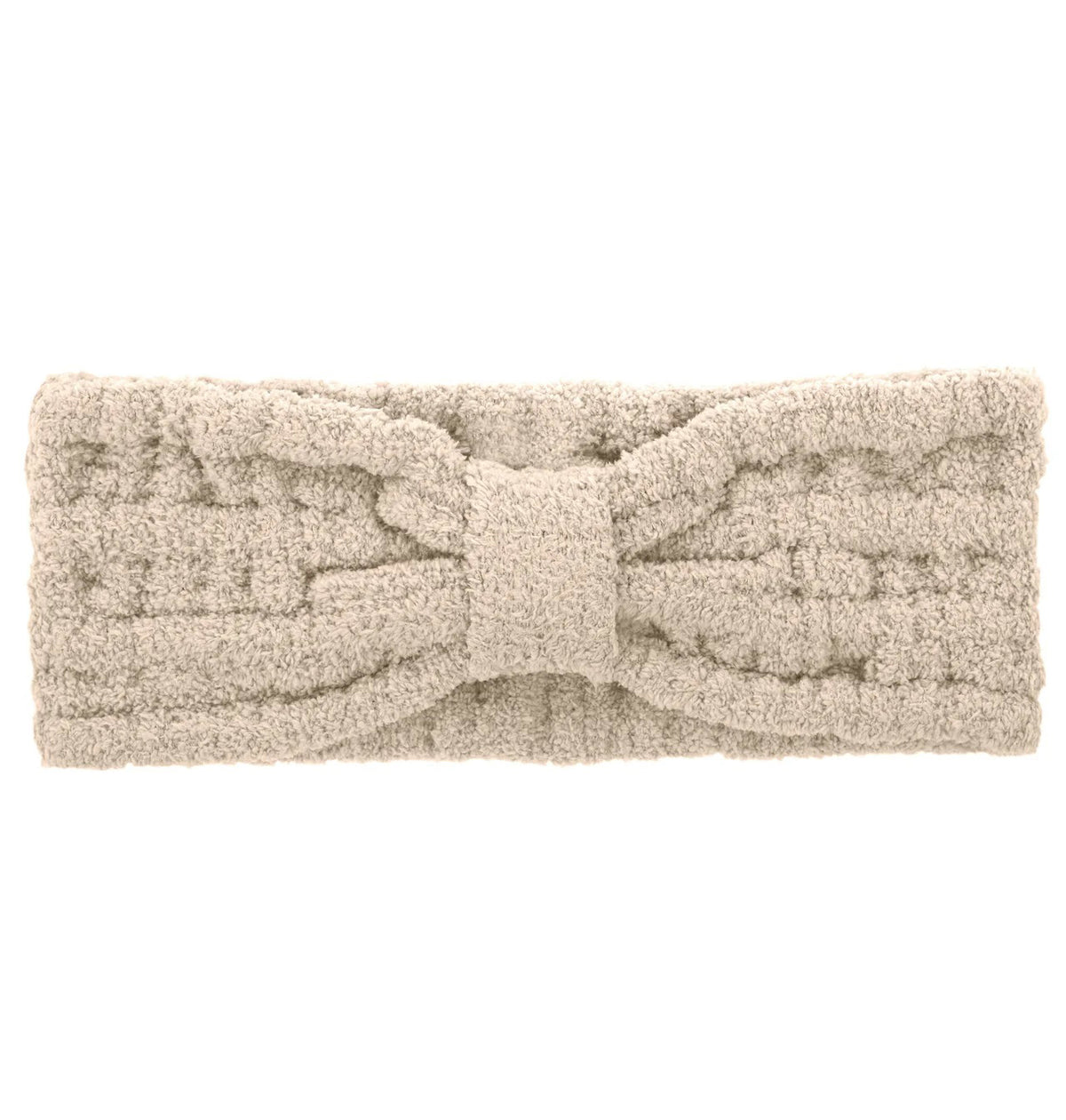 A person wearing a plush, white robe and a matching KASHWERE - HEADWRAP from KASHWERE stands against a plain background. They have long dark hair and are gently touching the collar of the robe, exuding contentment and tranquility as they embrace their self-care ritual.