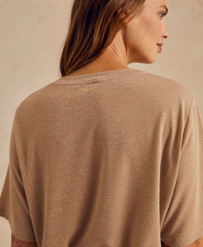 The MOMONI - IORA LUREX JERSEY T SHIRT by MOMONI is a red, short-sleeve, loose-fitting T-shirt with a subtle shimmer. Crafted from soft lurex jersey, this shirt features a round neckline and is made of a soft, lightweight material. Made in Italy. The background is plain white.