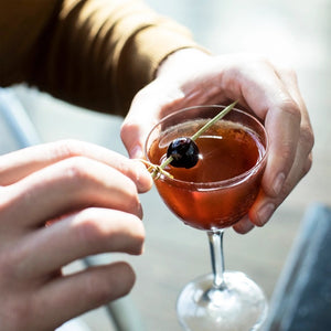 A clear glass bottle of Ritual Zero Proof Aperitif Alternative, featuring vibrant red liquid and a white label with bold black and yellow text—perfect for making a refreshing non-alcoholic spritz or Italian aperitivo.