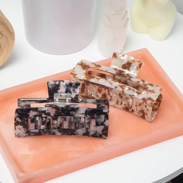 A rectangular, black marble-patterned KITSCH Eco Friendly Jumbo Open Shape Claw Clip, made from recycled materials, is displayed against a pale background with its “kitsch” branded packaging.