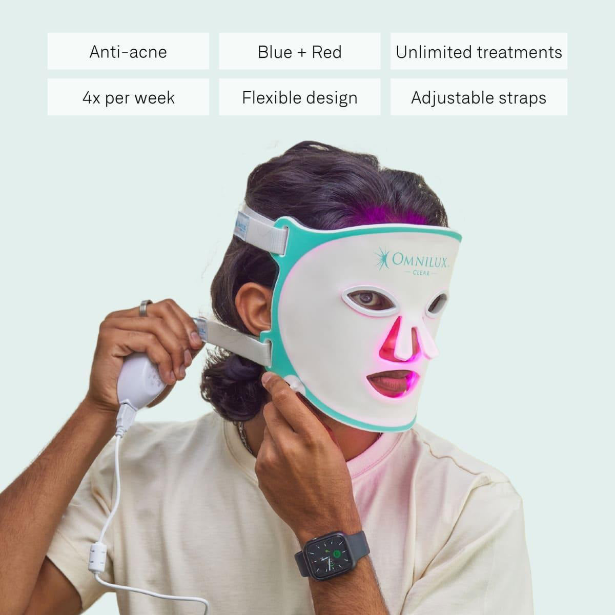 The OMNILUX CLEAR MASK, offering white and teal LED light therapy for acne with eye, nose, and mouth cutouts, uses blue and red clinically proven light therapy. It includes a controller, charging accessories, and an instruction manual.