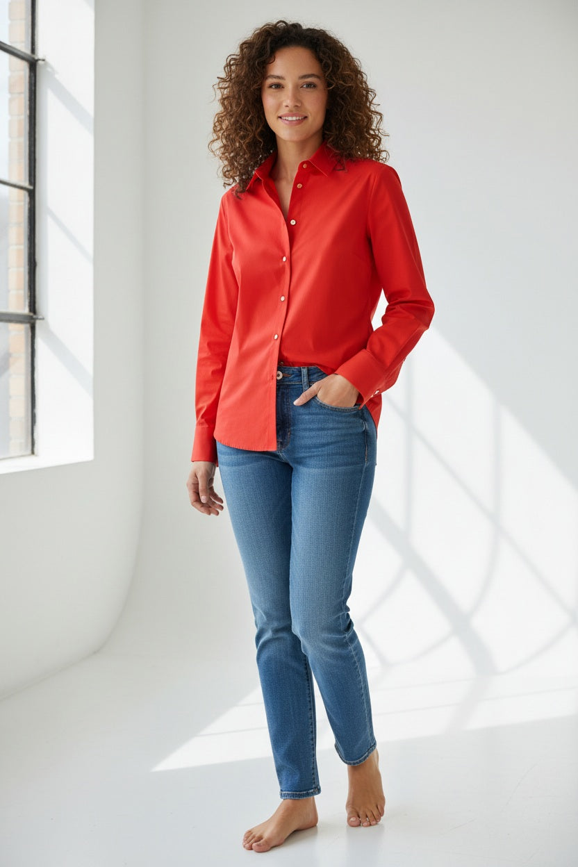 A person with straight brown hair wears the HINSON WU CLARICE Long Sleeve Shirt in Poppy and blue jeans, standing against a plain light background.