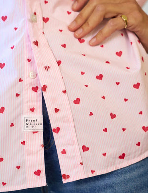 The FRANK & EILEEN Eileen Relaxed Button Up in pink stripe with red hearts is a long-sleeve, collared Italian cotton shirt displayed flat on a white background.