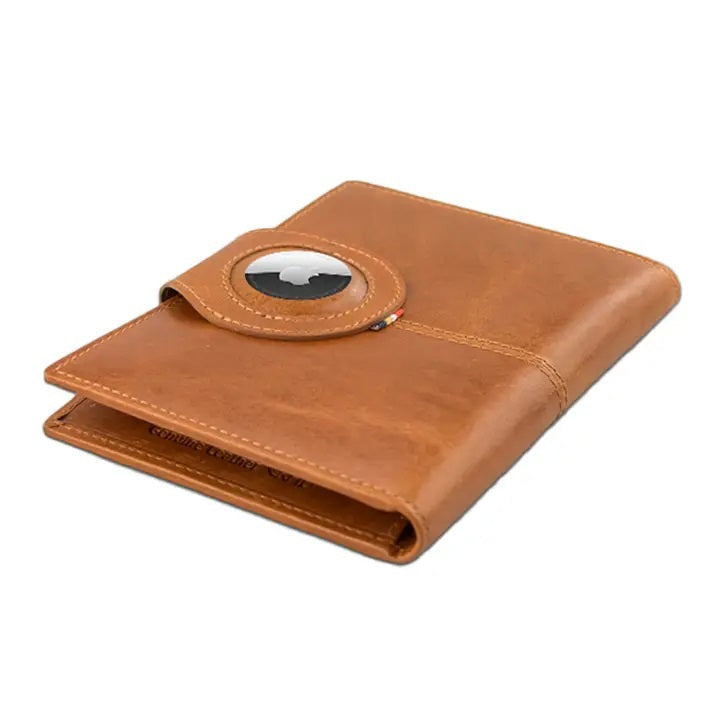 The GARZINI RFID-blocking leather passport holder in cognac features an AirTag compartment and opens to reveal card slots, a pen, and a burgundy passport—combining security with elegant organization.