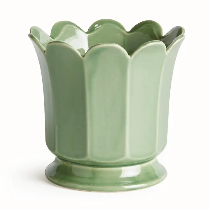 The NAPA HOME AND GARDEN Maline Footed Pot in Green, Large, features a light green ceramic finish with a scalloped, petal-like rim and a flared, rounded base. This elegant vase by NAPA HOME AND GARDEN is photographed against a plain white background.