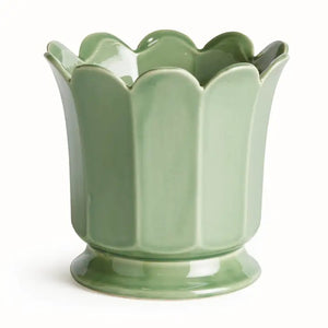 The NAPA HOME AND GARDEN Maline Footed Pot in Green, Large, features a light green ceramic finish with a scalloped, petal-like rim and a flared, rounded base. This elegant vase by NAPA HOME AND GARDEN is photographed against a plain white background.