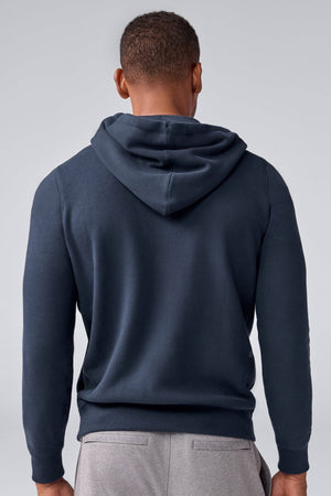 The MACK WELDON ACE Full-Zip Sweatshirt in True Navy Bird's Eye features a drawstring hood, long sleeves, and ribbed cuffs and hem—ideal men's loungewear—shown on a plain white background.