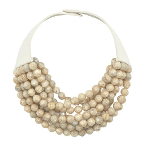 The FAIRCHILD BALDWIN - THE BELLA NECKLACE showcases layered strands of iridescent green Italian resin beads with a faceted design for a shimmering effect, finished with a smooth light green clasp that complements its vibrant hues.