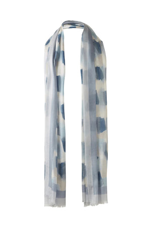 The KINROSS CASHMERE - BRUSHSTROKE PRINT CASHMERE SCARF by KINROSS features a lightweight, translucent fabric with a beige and white abstract geometric pattern and slightly frayed edges, displayed hanging to highlight its length.