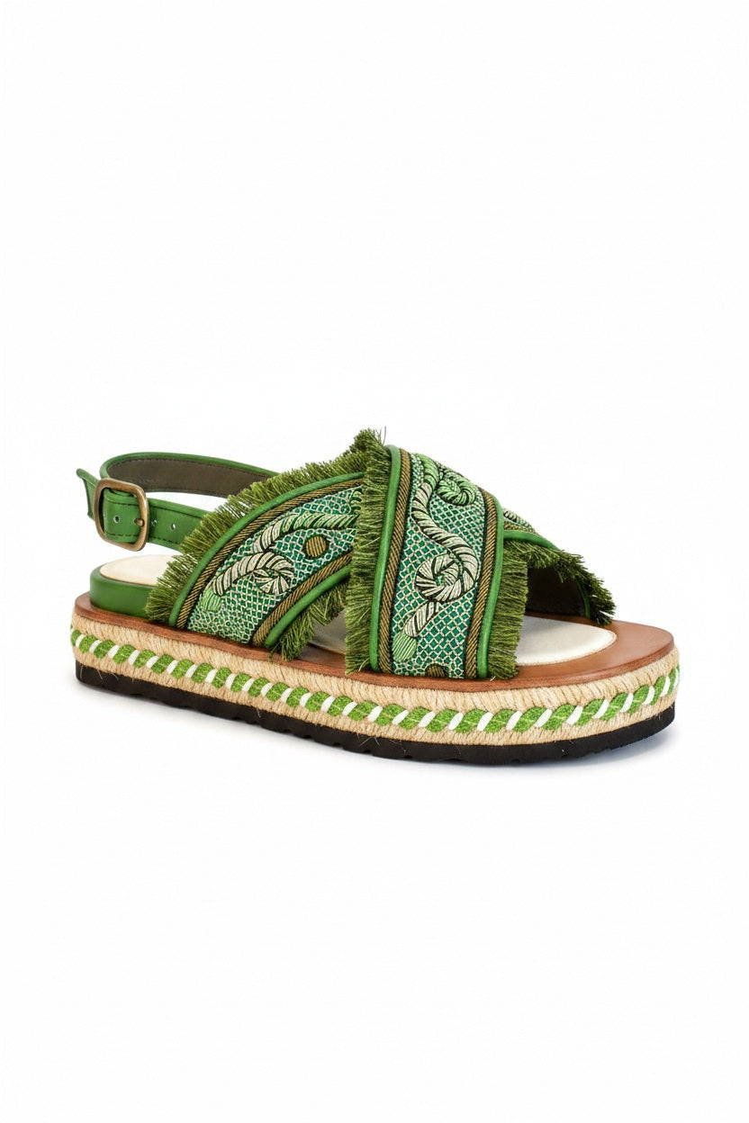 Explore the MEHER KAKALIA DA GAMMA BLOC sandal in Kelly Green Parrot, where comfort meets style. This open-toe sandal has a hand-embroidered design with fringe detailing, a thick textured sole with woven accents, an adjustable ankle strap, and a layered platform design.