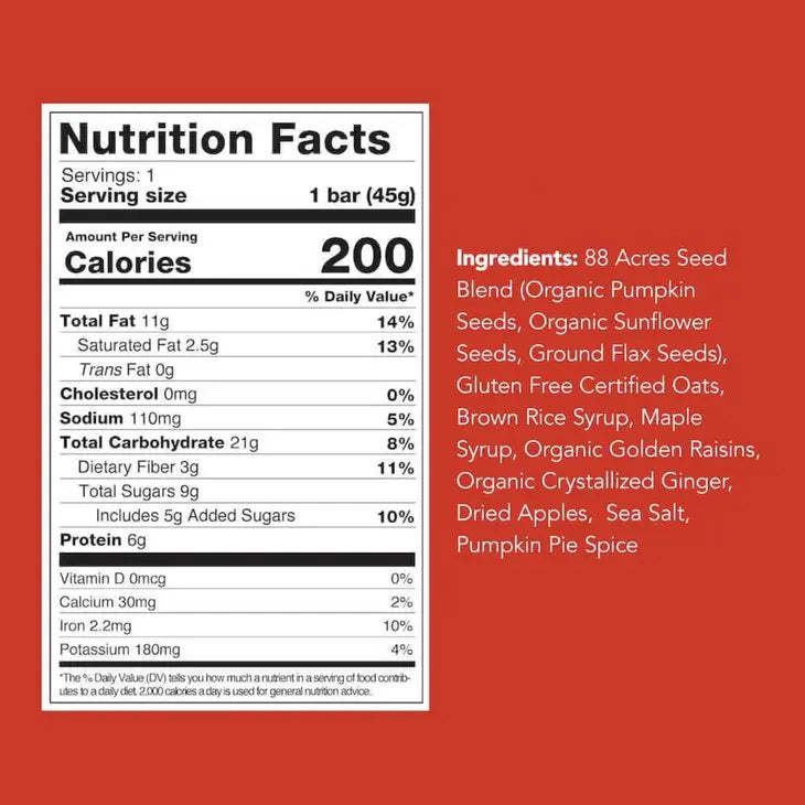 A package of 88 ACRES - APPLE GINGER CRISP SEED + OAT BAR rests on a light wooden surface. The primarily white and red wrapper emphasizes its nut-free, vegan, and gluten-free benefits. The bar is partially visible on the right side.