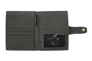The GARZINI RFID-blocking leather passport holder in carbon black features white stitching and a round cutout for an Apple AirTag, offering secure storage and easy tracking.
