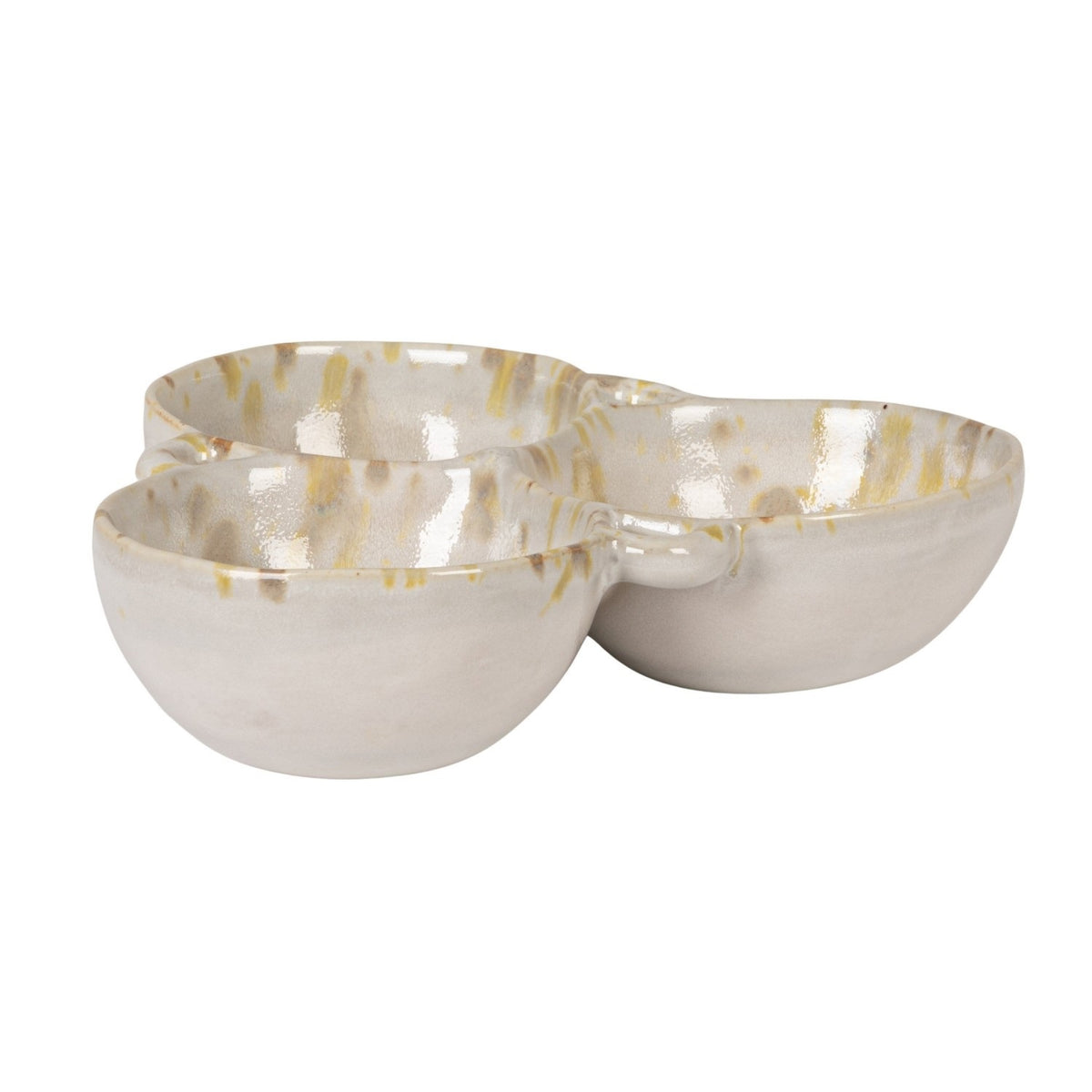 A rustic flat lay features the CREATIVE COOP 3-SECTION STONEWARE BOWL IN CREAM AND GREEN filled with spices, dried artichoke, garlic bulbs, vintage metal spoons, and assorted nuts on a textured beige surface.