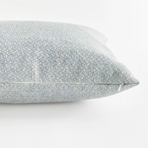 The NAPA HOME AND GARDEN - BLAKE SQUARE OUTDOOR PILLOW 20" is a pale blue, textured pillow with a subtle woven Jacquard pattern. Its soft, muted appearance adds weather-resistant elegance against a white background.