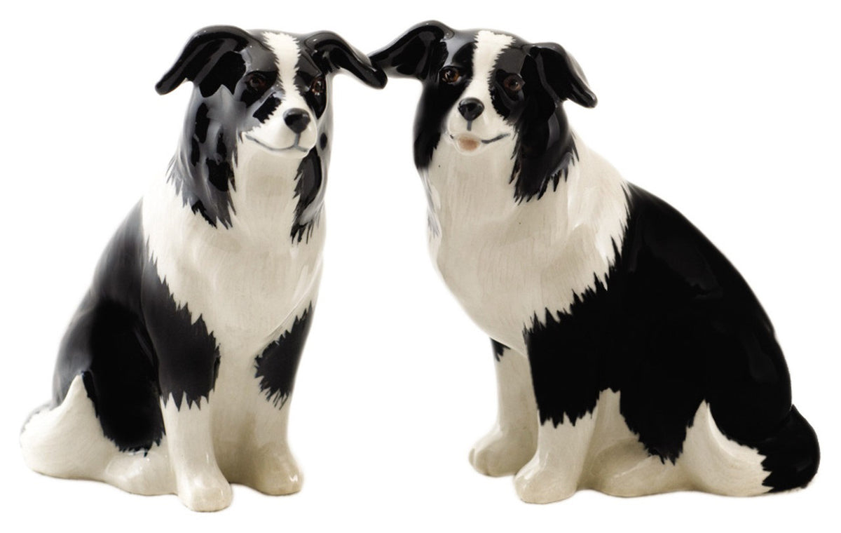 The QUAIL CERAMICS - BORDER COLLIE SALT AND PEPPER SET by QUAIL DESIGNS features two handpainted stoneware figurines with black and white coats, sitting side by side and facing forward—perfect for your table.
