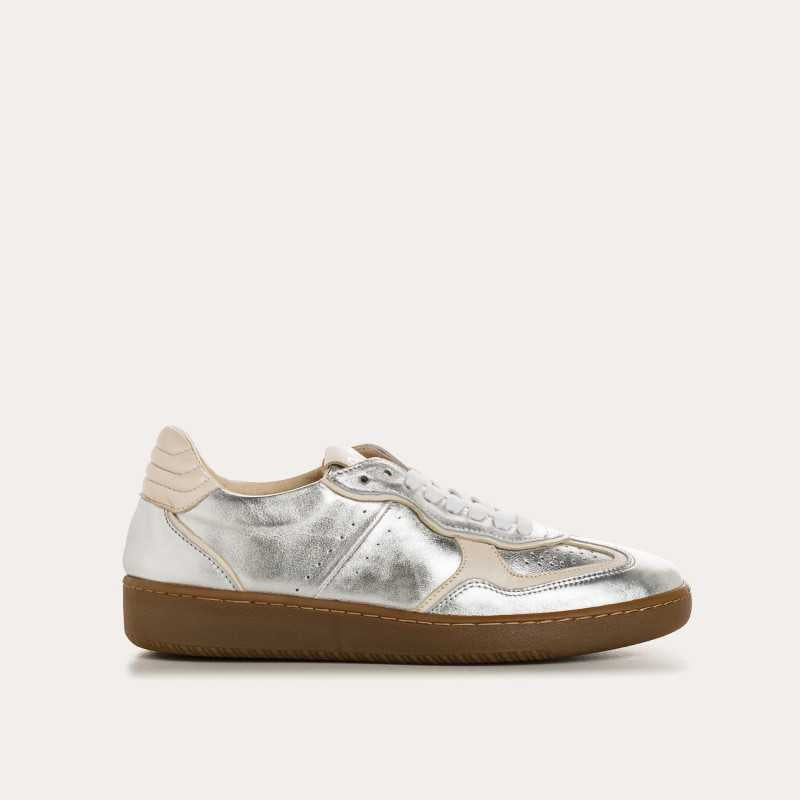 A top view of the REQINS - ATHENA METALLIC SNEAKER IN SILVER, featuring stylish silver suede, white laces, silver accents, and a beige sole by REQINS, displayed on a plain light background.