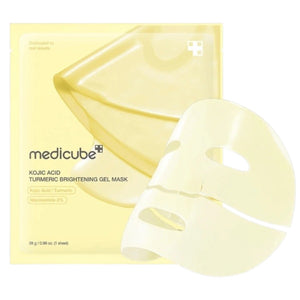 A woman wears the MEDICUBE - KOJIC ACID TURMERIC BRIGHTENING GEL MASK by KOSMIC KBEAUTY SKINCARE on one half of her face in its original gold jelly form, while the other half reveals the mask after it has turned transparent. Text highlights this Korean skincare treatment, infused with kojic acid and turmeric, which absorbs over 3-4 hours and transforms from gold to clear for a radiant, brightening effect.