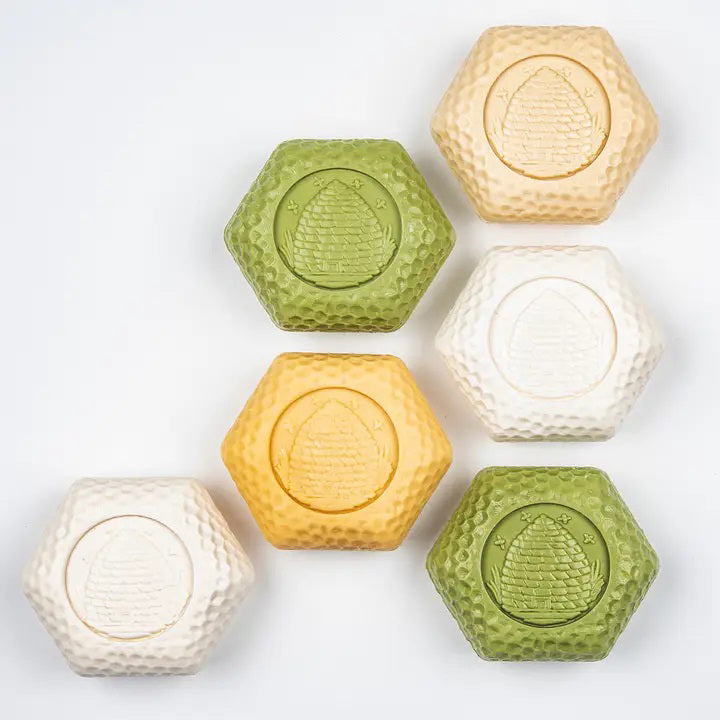 The BAUDELAIRE GOATS MILK HONEY SOAP 1.4OZ GIFT BOX includes eight hexagonal moisturizing soaps for sensitive skin in a vintage floral and bird-adorned box, offering classic charm and gentle care.