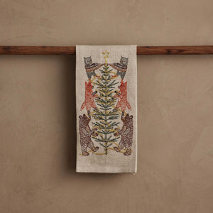 TINSEL TREE LINEN TEA TOWEL by CORAL & TUSK featuring embroidered owls, foxes, and bears decorating a tinsel tree for holiday decor.