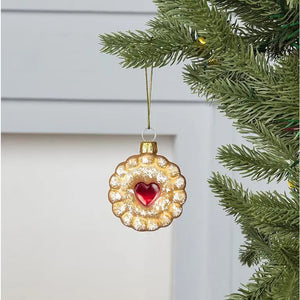 ABBOTT ICED COOKIE ORNAMENT: a round scalloped holiday cookie with a red heart-shaped center and a dusting of white sugar.