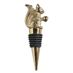The BE HOME - SQUIRREL BOTTLE STOPPER by BE HOME, INC features a gold squirrel with an acorn atop a tapered metal base and black rubber rings—perfect for wine lovers.
