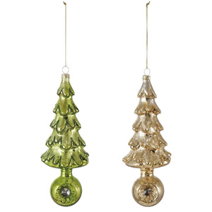Two textured, vintage-inspired Mercury Glass Tree Ornament with Witch’s Eye Base ornaments, one gold and one green with circular bases, nestled in a wooden box filled with paper shreds.