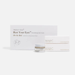 A set of MADISON GREEN - REST YOUR EYES ON THE BED relaxing eye masks and a small jar, all packaged in minimalist white with light brown text, displayed against a plain white background.