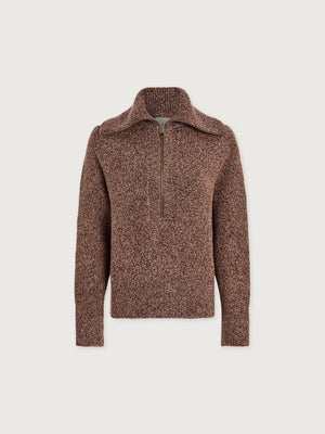 A person wearing a VARLEY - SHERIDA HALF-ZIP KNIT SWEATER IN GINGERBREAD FLECK, a brown speckled boucle yarn sweater with a collared half-zip neckline.